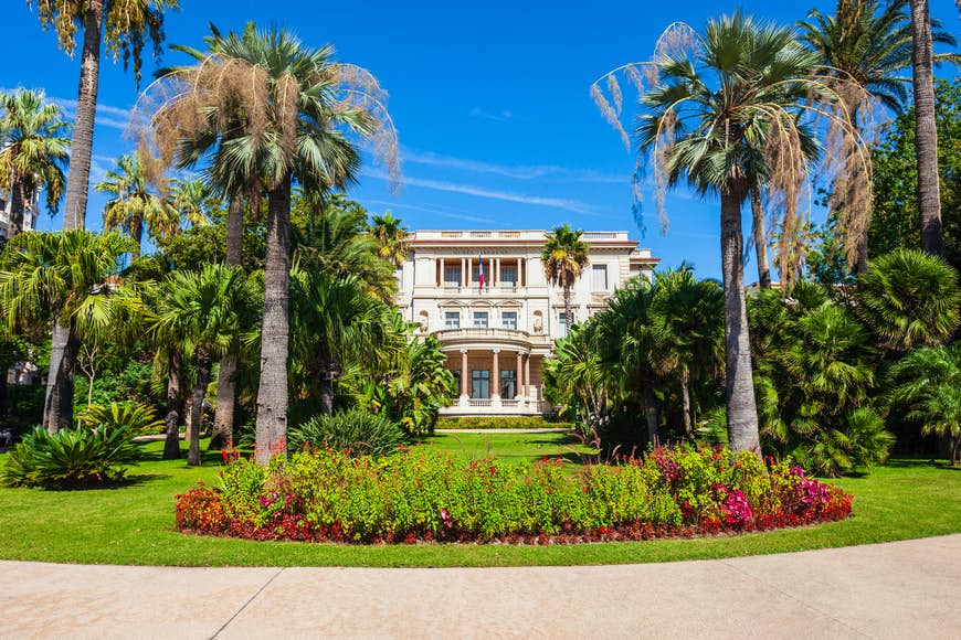 The exterior of a belle epoque mansion with landscaped gardens