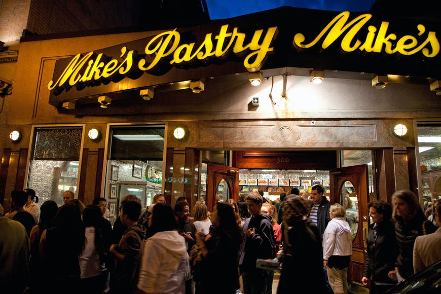 A crowd gathers in front Mike’s Pastry on Hanover Street in the North End, Boston, Massachusetts, USA