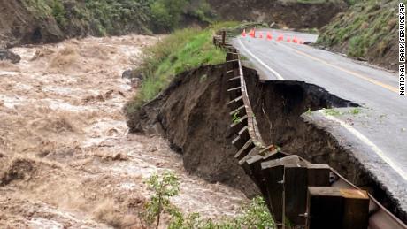 A road in Yellowstone National Park partially collapsed due to flooding Monday.