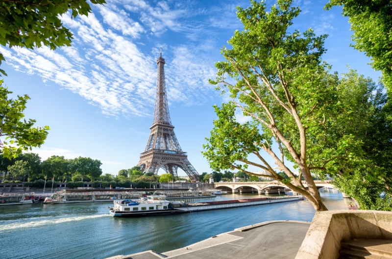 boat cruising down the river Seine with the Eiffel Tower in the background