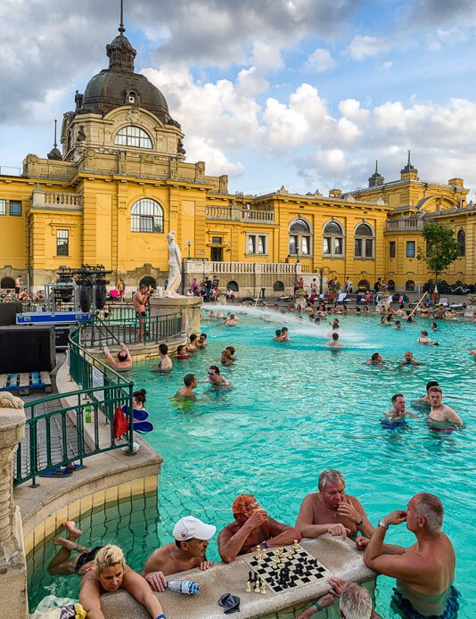 people in the swimming pool Szechenyi thermal bath in Budapest, Hungary