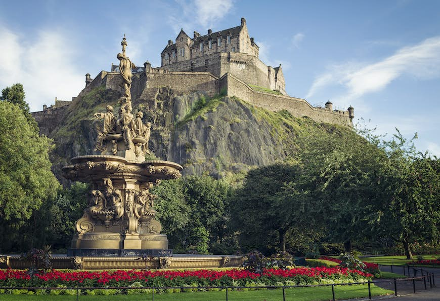 Flowers surrounding the ornate Ross Fountain in Princes Street Gardens in Edinburgh, with Edinburgh Castle in the background