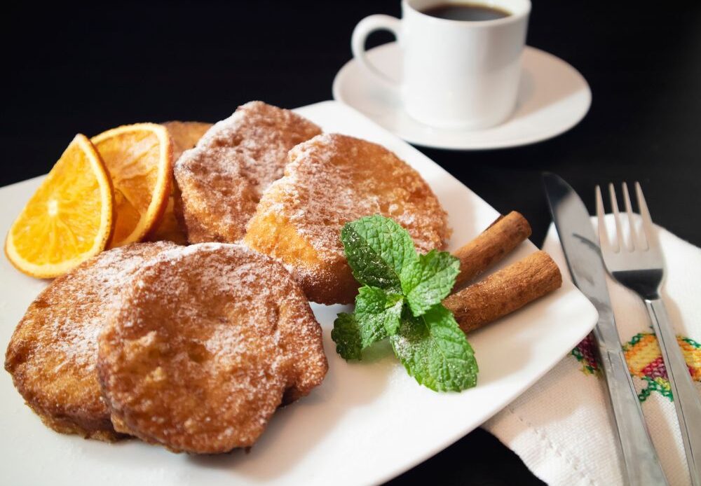 A Spanish breakfast of Torrijas served with a coffee.