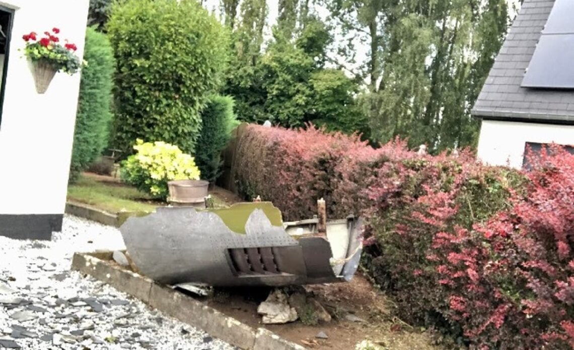 Couple shocked as 747 plane engine falls through shed roof