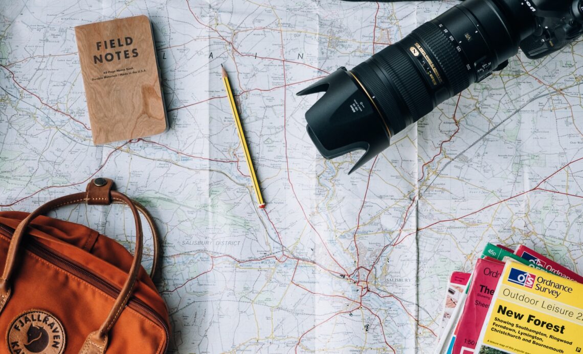 Maps and a camera serve as travel inspiration (photo: Annie Spratt)