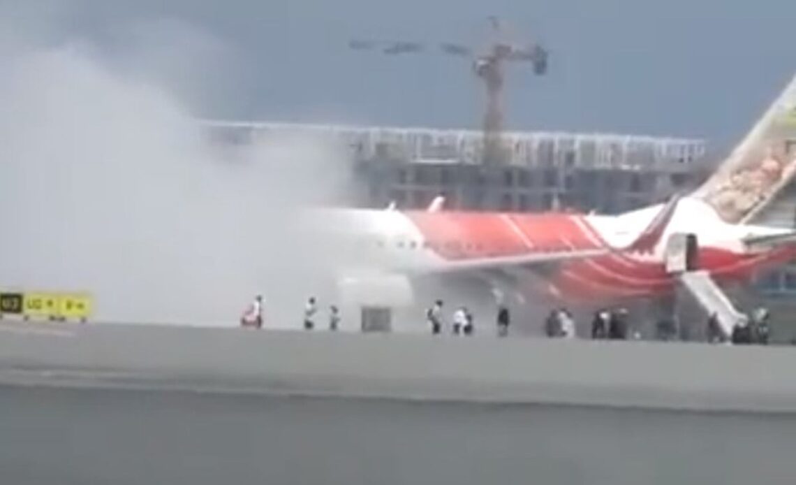 Smoke pours from Air India flight as passengers rush to evacuate