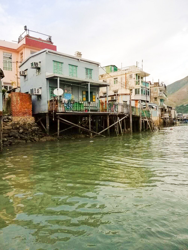 row of stilted homes on river