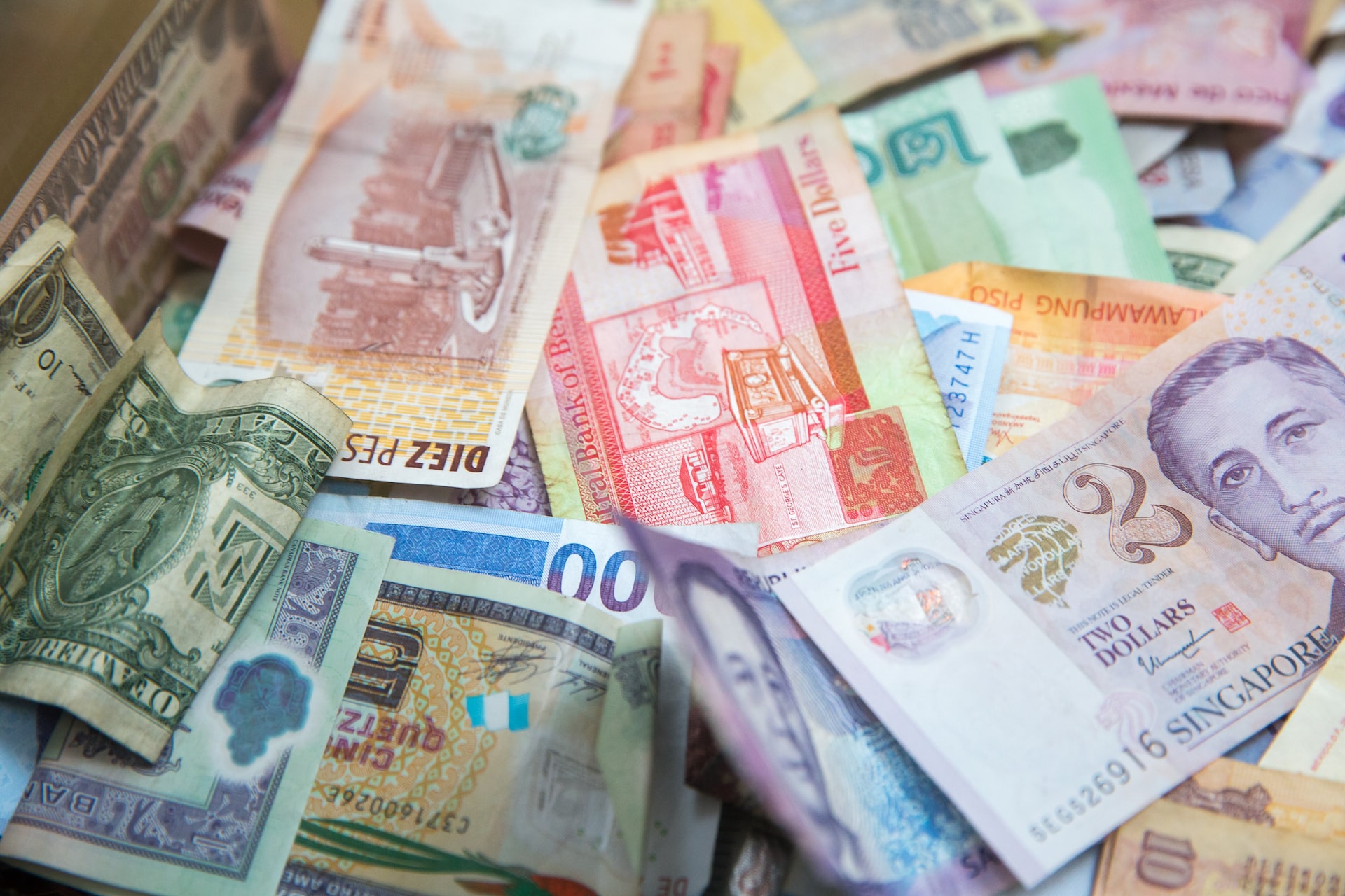 Not budgeting wisely is a common travel mistake to avoid. Pictured: various currencies (photo: Jason Leung)
