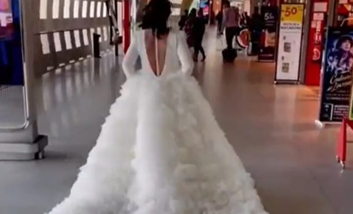 Bride seen sprinting through Paris airport in enormous wedding dress