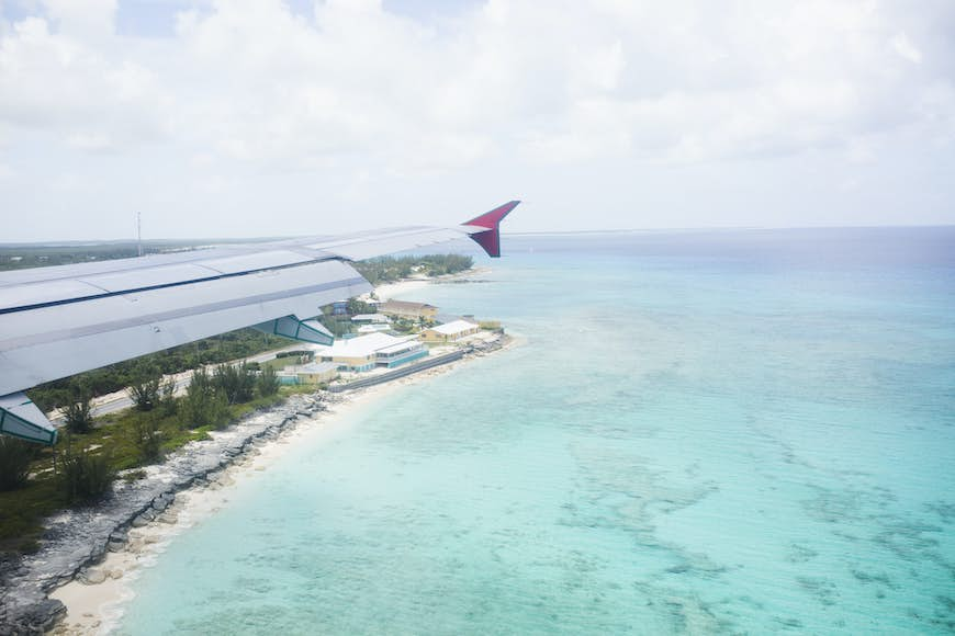 Aerial view of a flight passing over San Salvador island and turquoise waters