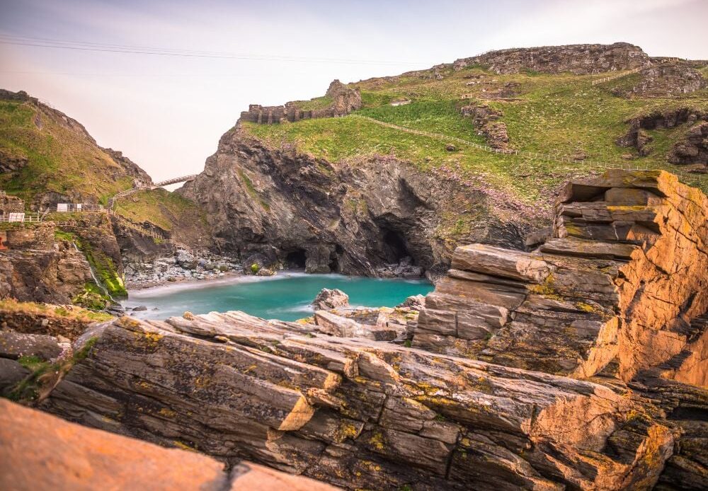 The ruins of Tintagel Castle on Tintagel Island at sunset.