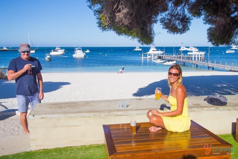 woman sitting on a wooden table on the beach