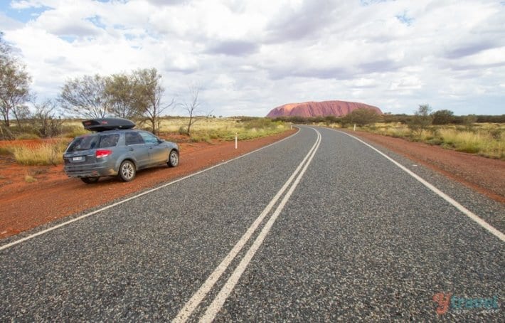 car on the road to uluru