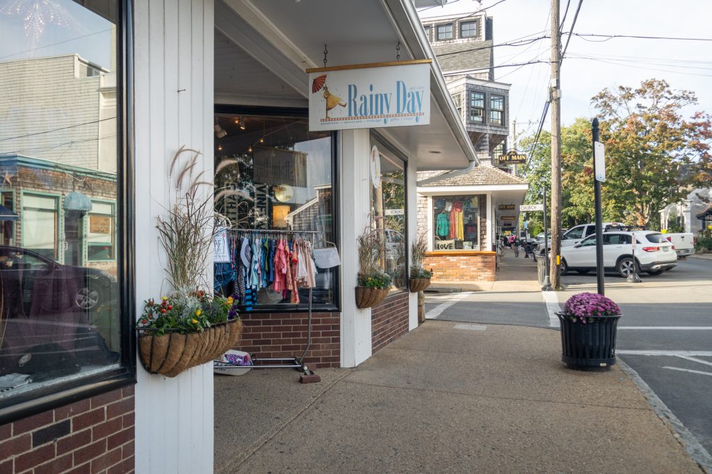 A row of shops with a sign reading "Rainy Day Gifts"