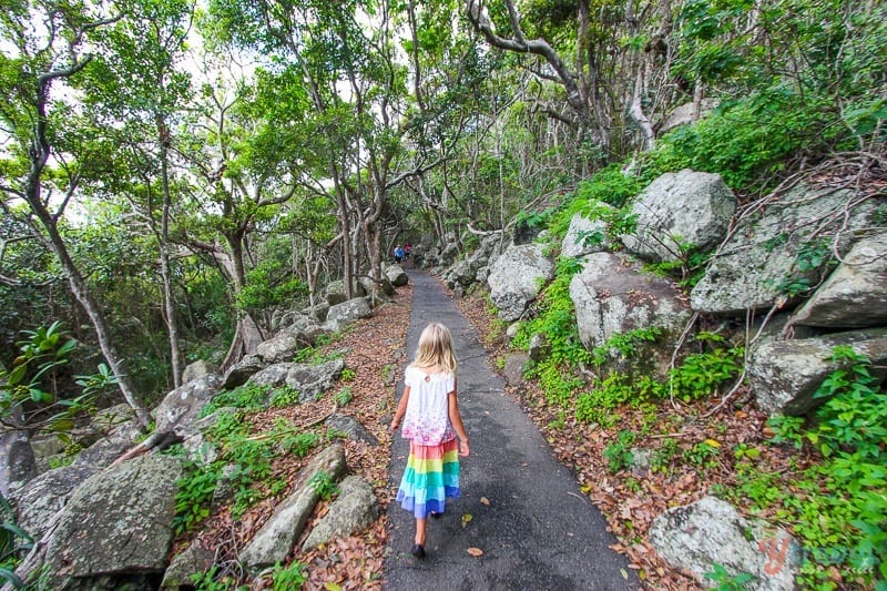 gilr walking along path in Burleigh Heads National Park, Gold Coast, Australia