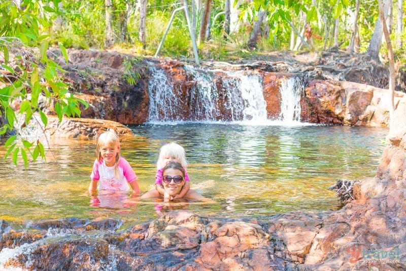 woman and daughters swimming in the Buley Rockhole  surrounded by lush vegetation