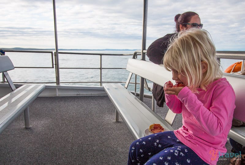 girl eating on boat