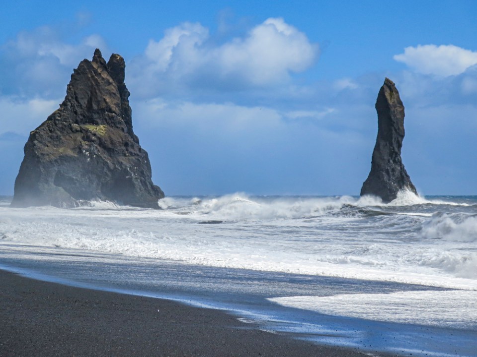 Stormy, moody day on black sand beach Reynisfjara on the south of Iceland, Europe, huge waves on Atlantic Ocean