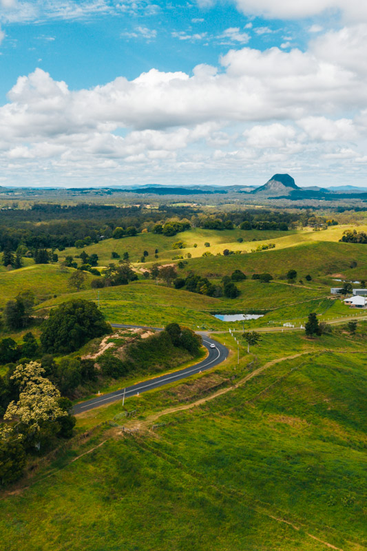 Driving through the rolling hill with Mount Cooroora, Pomona in the background