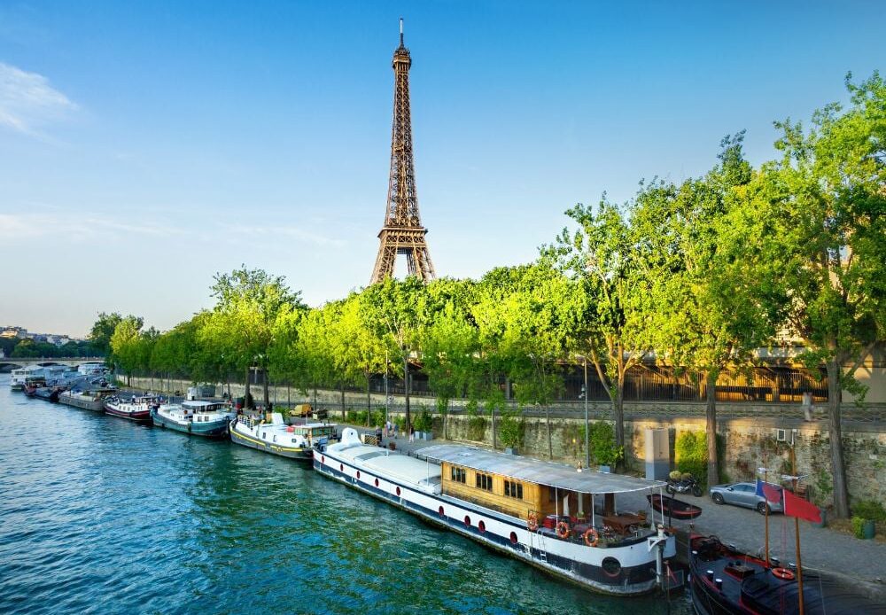 A beautiful scenic view of Eiffel Tower from afar along the river.