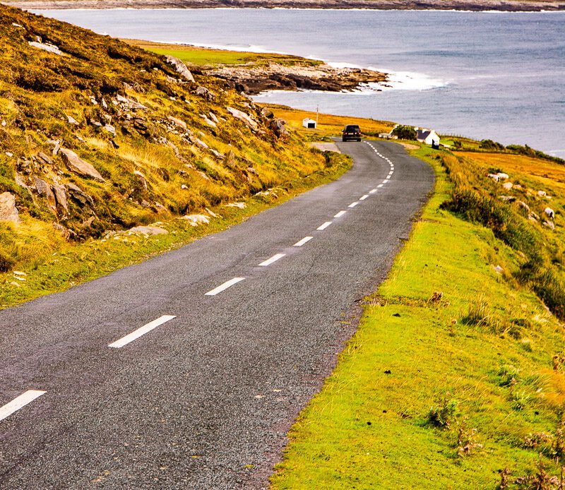 Coastal road sloping downhill towards the ocean