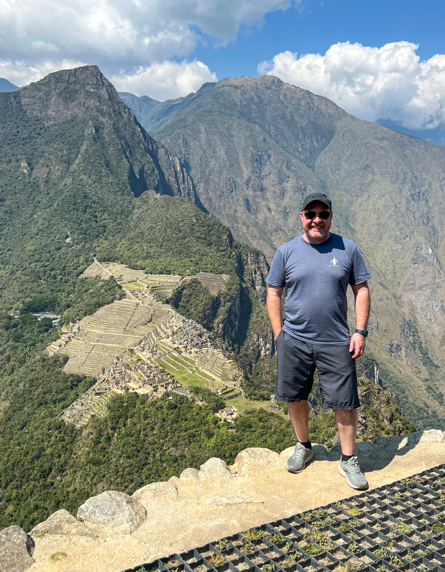 Dave in Peru standing atop Huayna Picchu with Machu Picchu below.