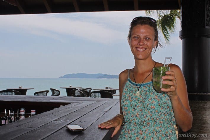 woman holding cocktail at the private beach bar Shangrila Tanjung Kota Kinabalu Malaysia