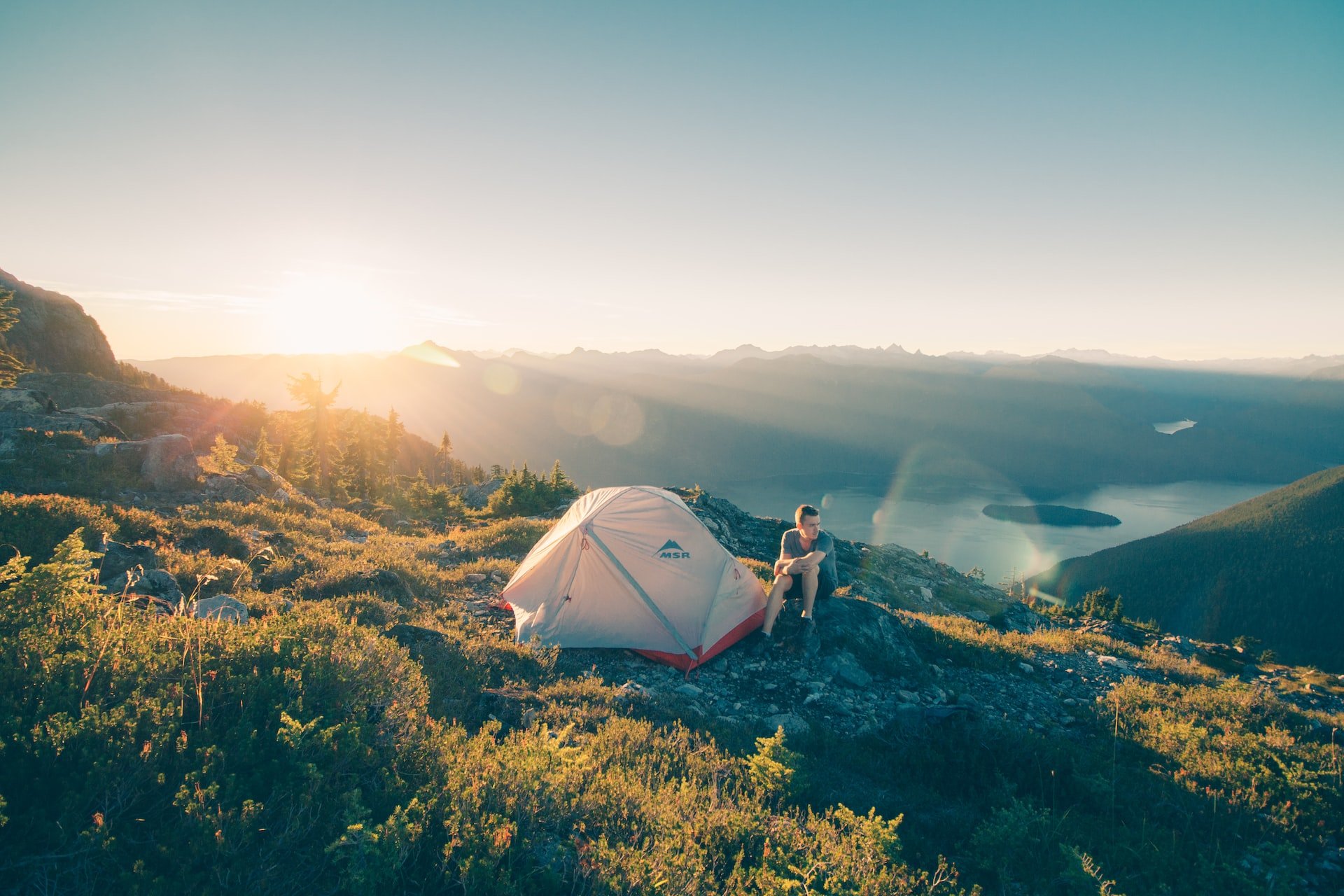 Man with tent at sunset in Golden Ears Provincial Park, Canada (photo: Glen Jackson)