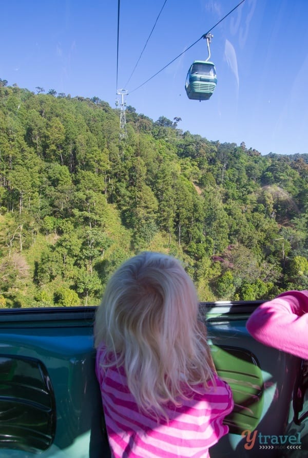 girls sitting in a gondola looking at the view