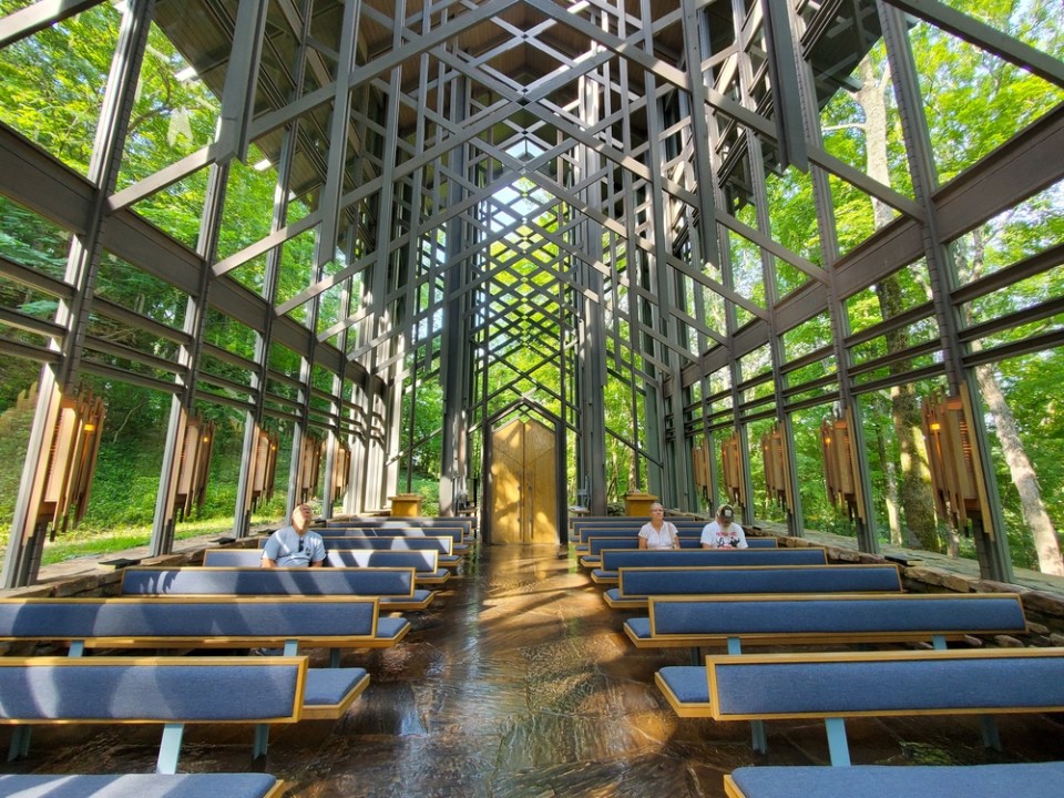 The unique architecture inside of the Thorncrown Chapel surrounded by green forest