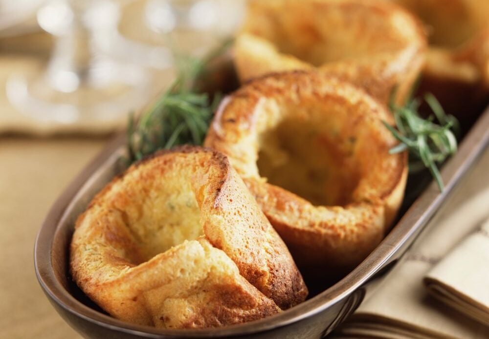 Freshly baked Yorkshire puddings on a baking tray
