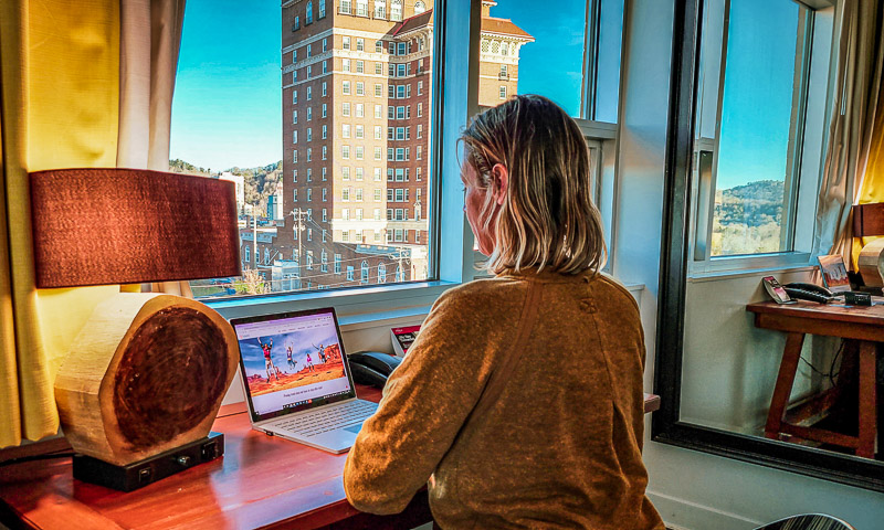 woman on computer at hotel desk