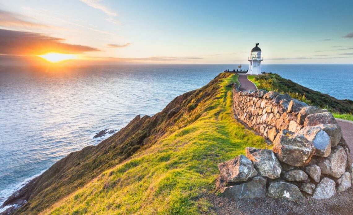 Cape Reinga lighthouse with the sun setting in New Zealand