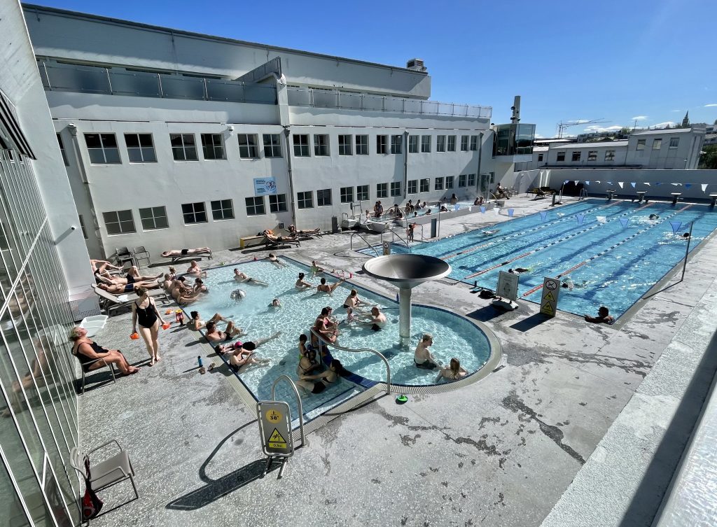 Locals swimming and bathing at Reykjavik's public swimming pool.
