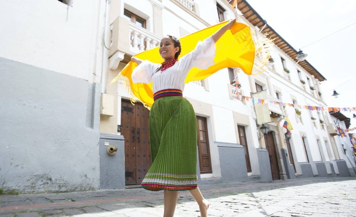 A female dancer with a yellow scarf on the street in Quito, Ecuador