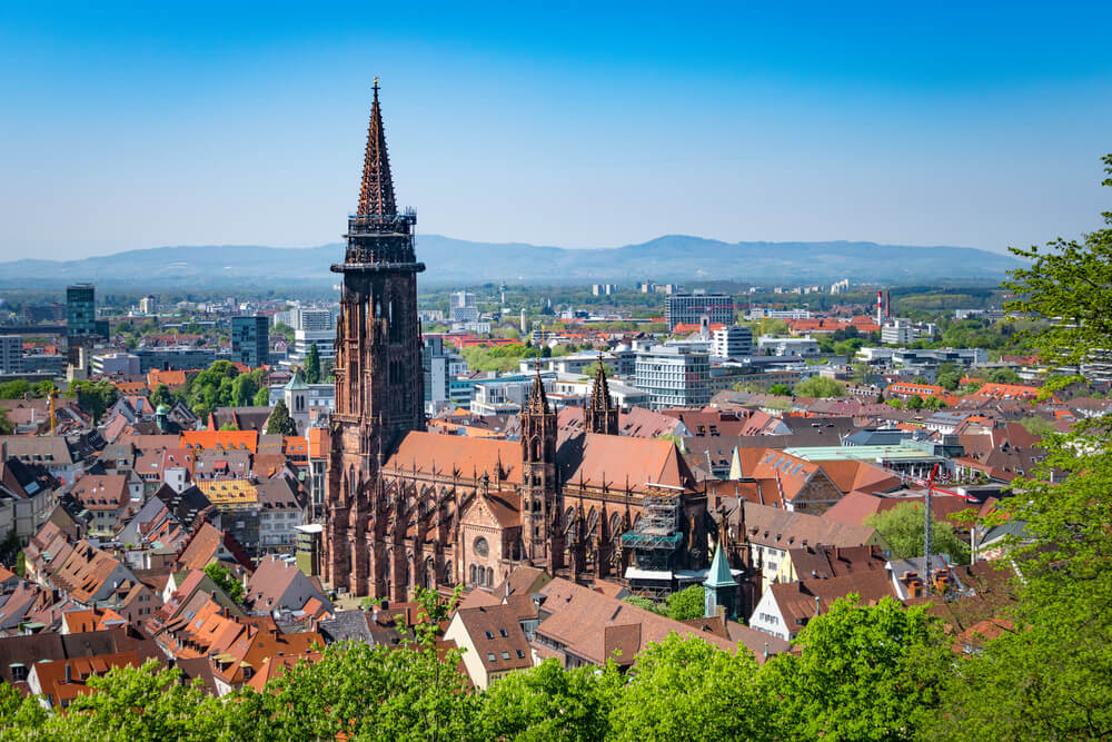 aerial view of freiburg's old town with mountains in the background