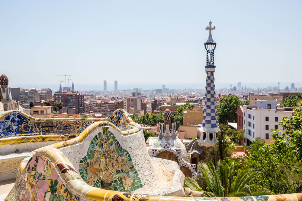 Gaudi mosaic tiled seats and sculptures and view overlooking barcelona