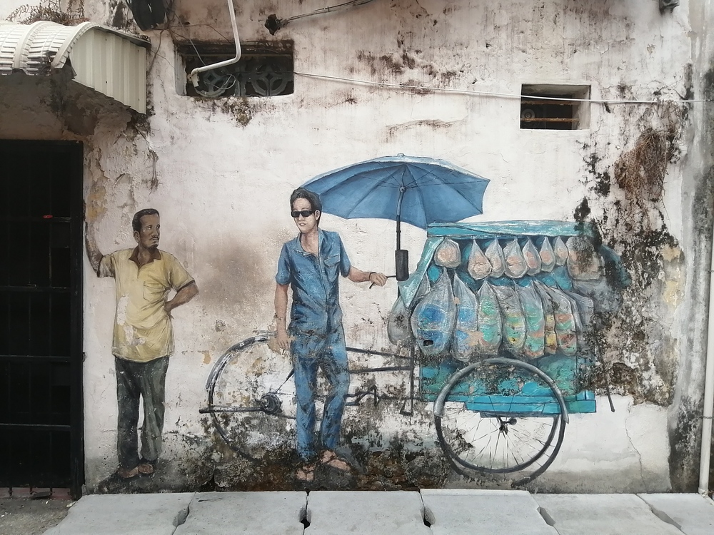 man on bicycle street art 