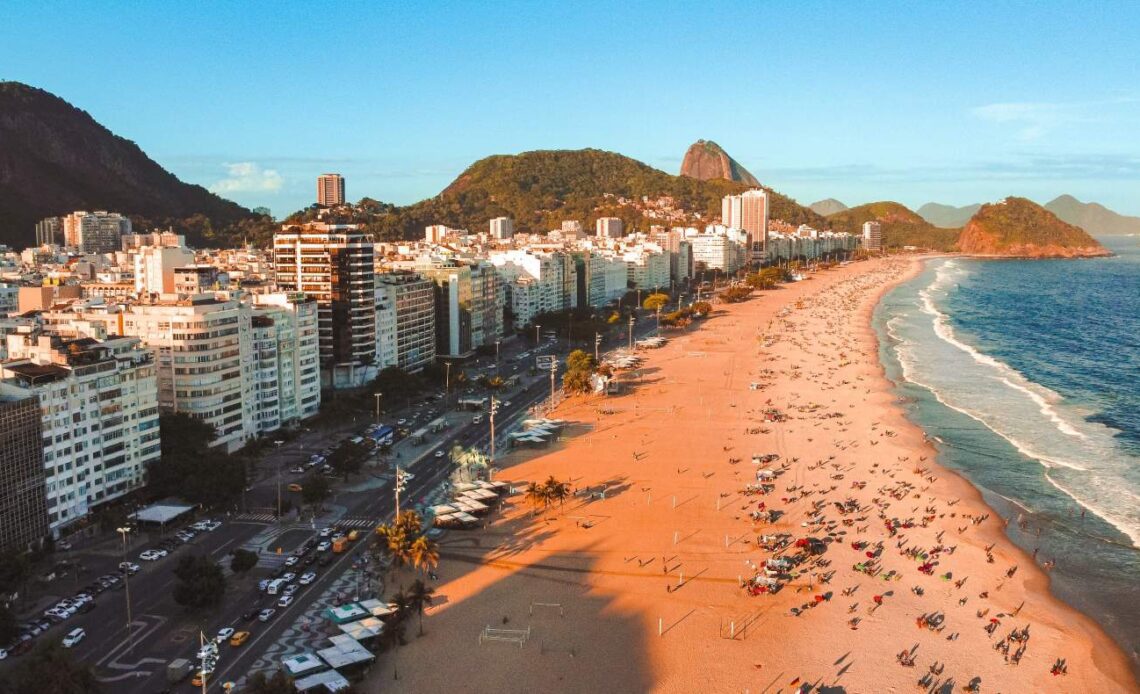 Long stretch of beach lined with multistory buildings in Rio de Janeiro, Brazil