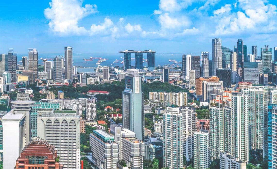 The Singapore city skyline, densely packed with skyscrapers on a sunny day
