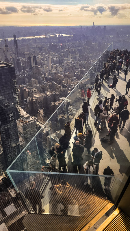 people standing on the edge lookout platform with views of NYC