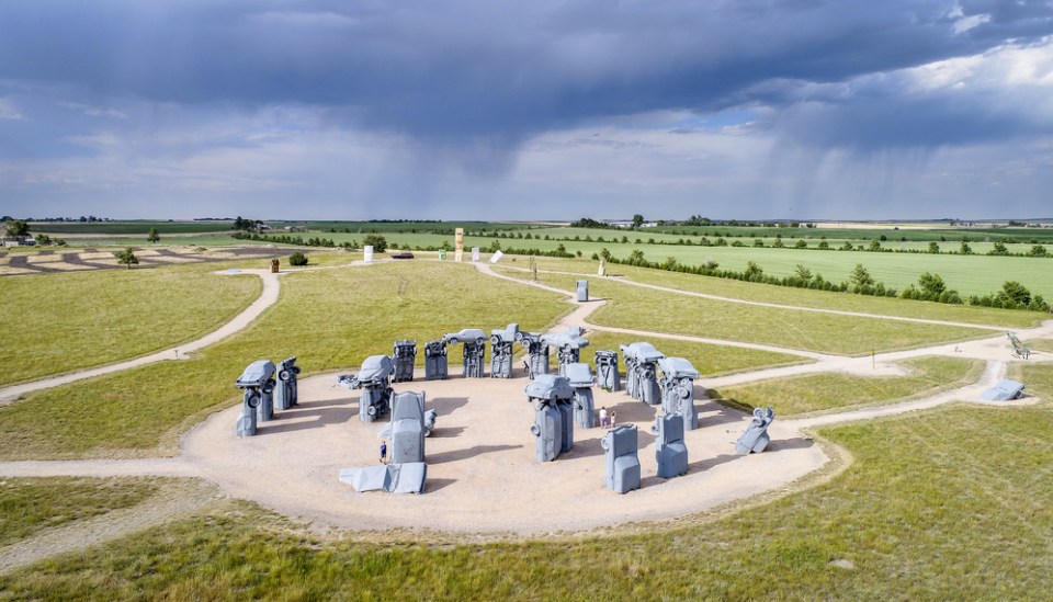 Carhenge - famous car sculpture created by Jim Reinders, a modern replica of England's Stonehenge using old cars., aerial view with a storm in background
