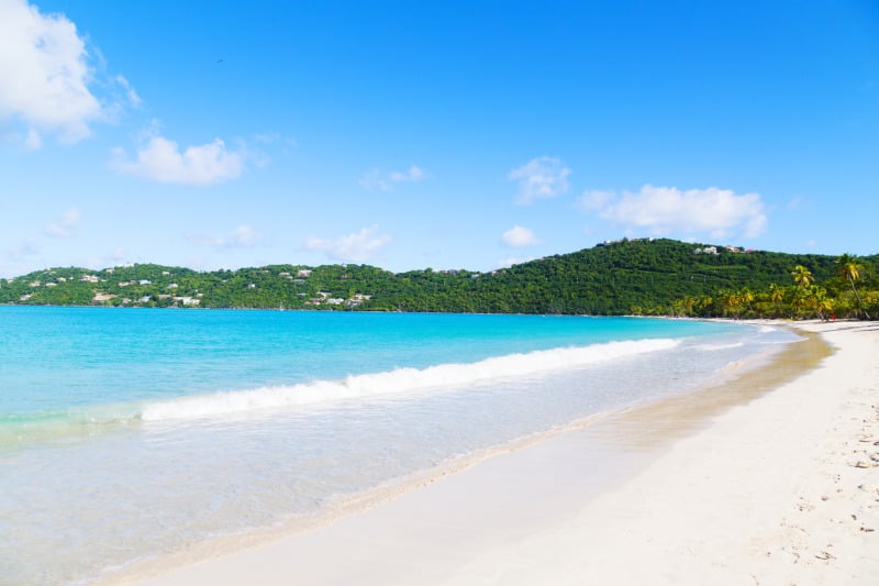 Spectacular Magens Bay beach in the morning on St Thomas Island, US VI. Scenic beach view with palms, white sand and rolling waves.