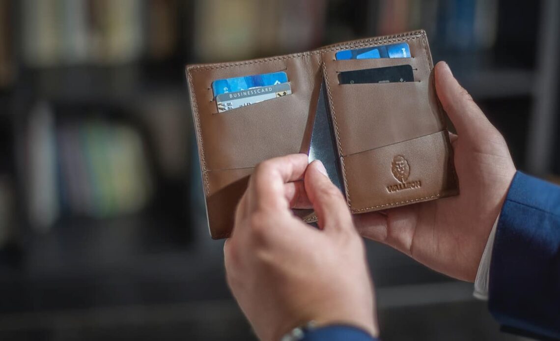 a person reaching for a credit card in their wallet