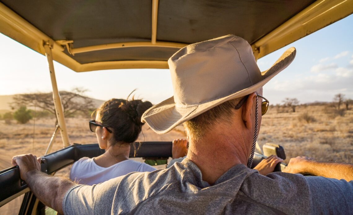 Two people looking out of a Jeep Safari in Kenya, Africa