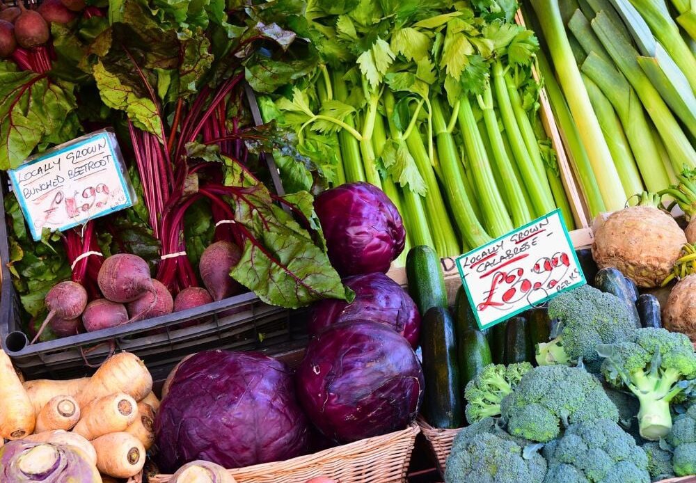 A diverse range of farm-fresh fruits and vegetables, including a variety of produce, is available at the bustling weekly market in Cirencester.