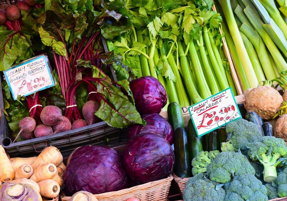 A diverse range of farm-fresh fruits and vegetables, including a variety of produce, is available at the bustling weekly market in Cirencester.