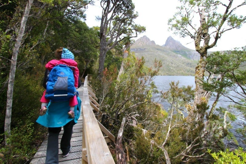 people walking on a boardwalk