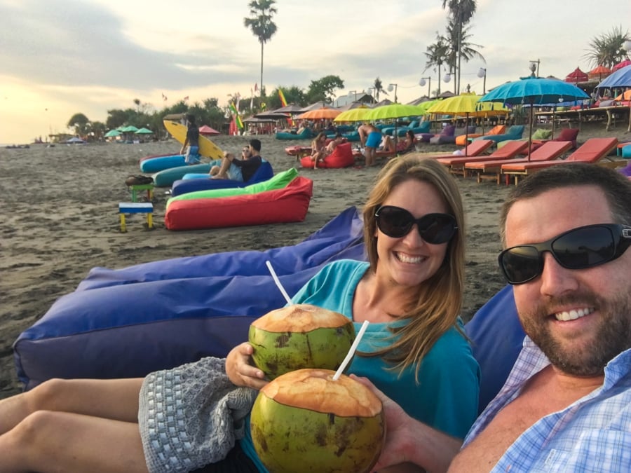 nick & dariece digital nomads from Goats On The Road drinking coconuts on the beach