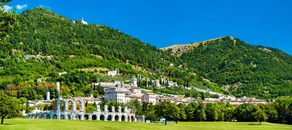 View of Gubbio with roman theatre and medieval towers in Umbria, Italy